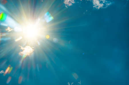 radiant sun in the blue sky, closeup, natural backgroundの写真素材