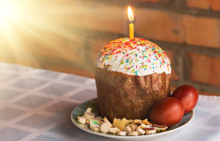 holiday pie with lighted candl on the table at Christian holiday Easter with eggs and horseradishの写真素材