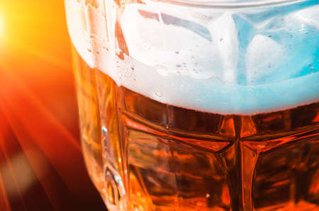 light beer closeup in large glass, alcohol on a nature backgroundの写真素材