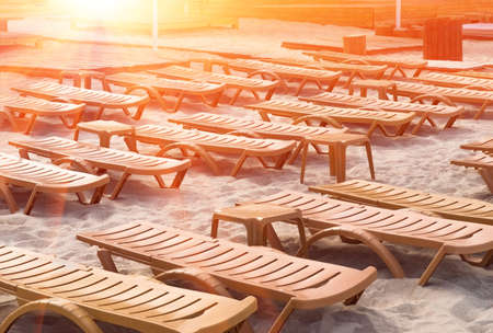 Beach sun loungers stand on the sand, for summer warm morning restの写真素材