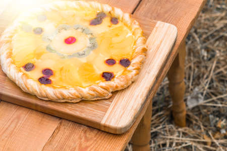 Fruit pizza with pineapple, orange, cherries, cream, jelly, kiwi, home-made isolated on white background closeupの写真素材