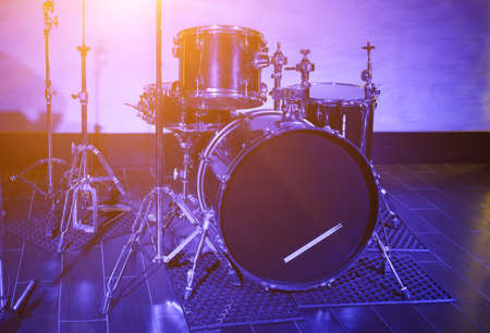 drum kit in blue light standing on a musical scene closeupの写真素材
