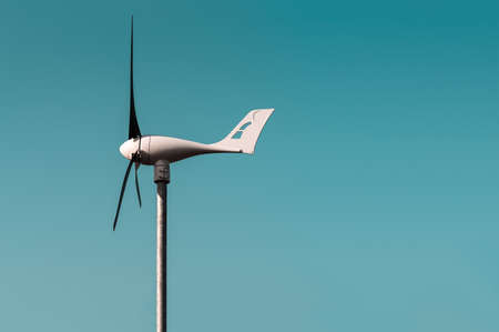 Wind turbine against the blue sky, closeup