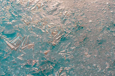 The texture of the frozen blue ice in the lake, closeup, winter background