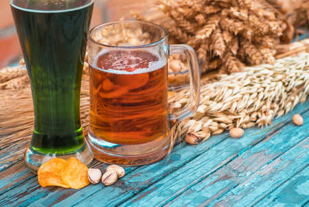 Mug of light beer and green Irish beer close-up in Patrick's Day. Beer in a glass closeupの写真素材