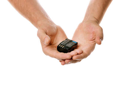 battery off camera in the hands is isolated on a white background. Concept of battery recycling. Battery in the hands. The hands isolated on white backgroundの写真素材