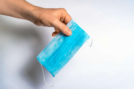 Protective face mask in hand. Surgical mask. Medical mask and coronavirus protection.