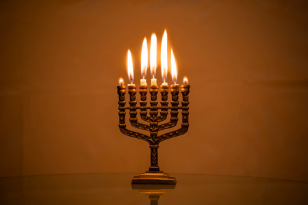 Hanukkah menorah closeup with burning candles for holiday card background. Retro old style hanukkah holidayの写真素材