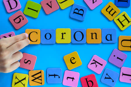 Young child spelling the word corona with colorful toy lettersの写真素材