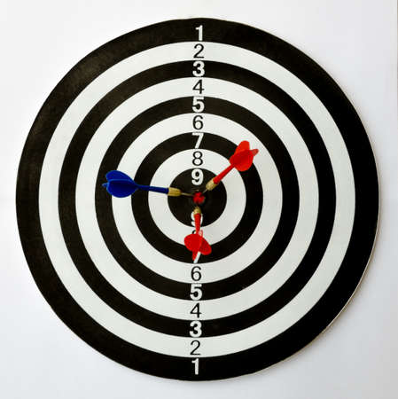 Dartboard with three darts on the bulls eye.の写真素材