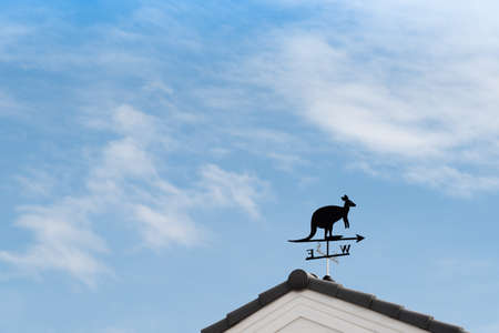 Weathervane with kangaroo above an arrow and the four cardinal points North East West Southの写真素材