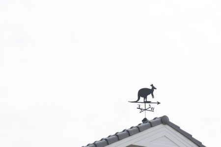 Weathervane with kangaroo above an arrow and the four cardinal points North East West Southの写真素材