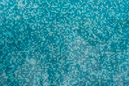 Mosaic bottom of swimming pool when watched through wave ripple.の写真素材