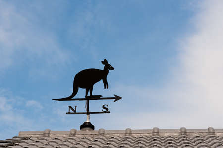 Weathervane with kangaroo above an arrow and the four cardinal points North East West Southの写真素材