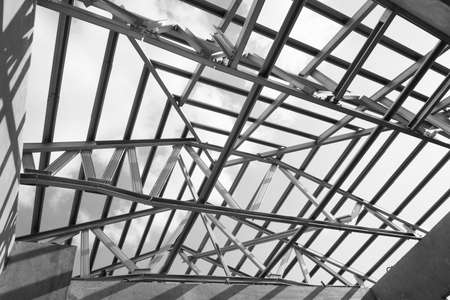 Black and white photo,Structure of steel roof frame for building construction.The advantage of this structure is lightweight but strong.の写真素材