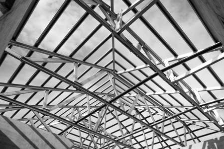 Black and white photo,Structure of steel roof frame for building construction.