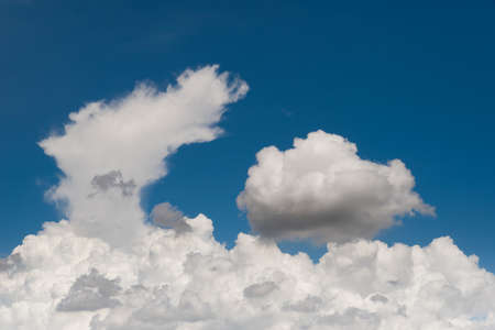 Blue sky background with a white clouds in a sunny day.