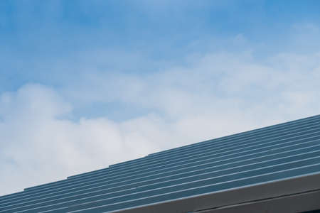 Structure of steel roof frame for building construction on sky background.