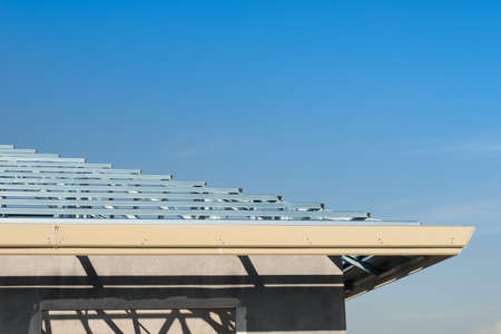 Structure of steel roof frame for building construction on sky background.の写真素材