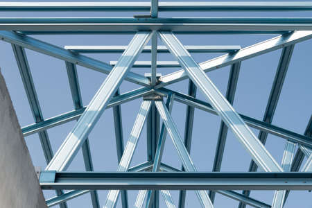 Structure of steel roof frame for building construction on sky background.の写真素材