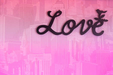 Valentine day background with word Love on pink wall background.