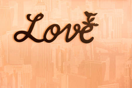 Valentine day background with word Love on orange wall background.の写真素材