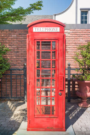 Vintage style image of typical red telephone box.