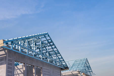 Structure of steel roof frame for building construction on sky background.の写真素材