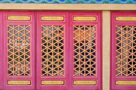 Traditional and architecture red window chinese style temple at Wat Mangkon Kamalawat or Wat Leng Noei Yi in Nonthaburi,Thailand.の写真素材