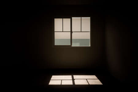 Light from windows shine on the floor in dark room.の写真素材