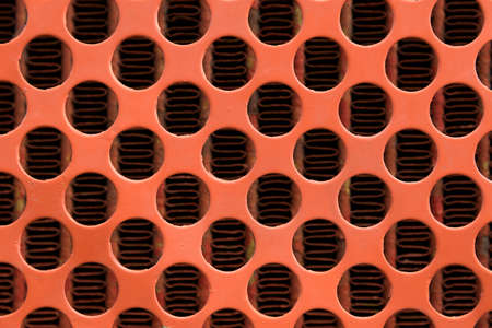 Pattern of orange a steel grating background.