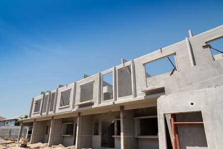 Row of Townhouse prefabricated building isolated on blue sky background.
