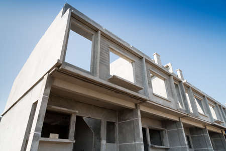 Row of Townhouse prefabricated building isolated on blue sky background.