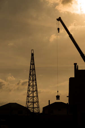 Silhouette of construction site before the sunset.の写真素材