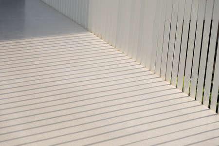 The shadow shining down on the floor of walkway in the afternoon.
