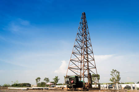 Pile driving machine with reinforced concrete piles on construction site.の写真素材