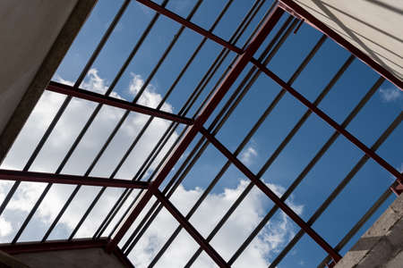 Up view of Structural steel beam on roof of building residential construction.