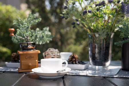 A cup of coffee on table in cafe located in the park, Time of relaxation.