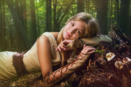 Blond girl in a magic forest