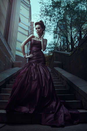 Beautiful woman in violet dressの写真素材
