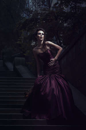 Beautiful woman in violet dressの写真素材