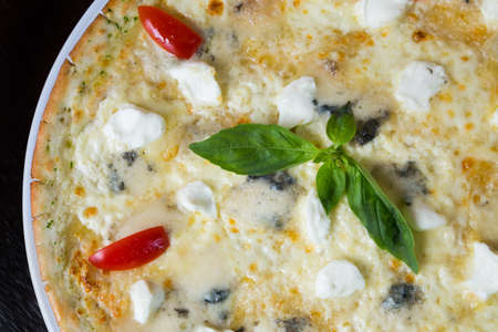 Appetizing pizza with mozzarella cheese and seafoodの写真素材