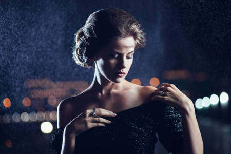 Woman posing in the rain の写真素材