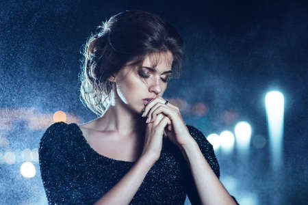 Woman posing in the rain の写真素材