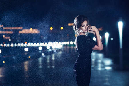 Woman posing in the rain の写真素材