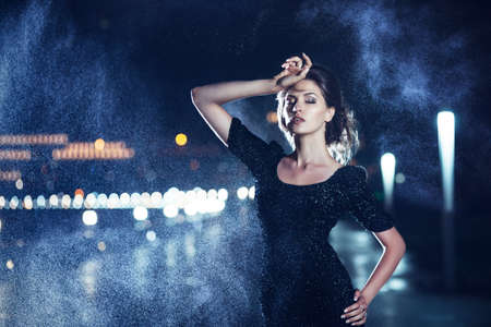 Woman posing in the rain の写真素材