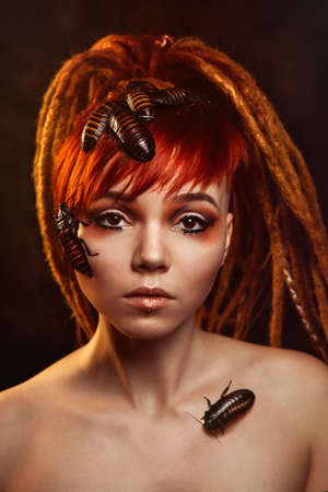 Portrait of a young woman with cockroachesの写真素材