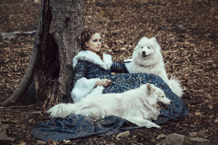 The woman on winter walk with a dogの写真素材