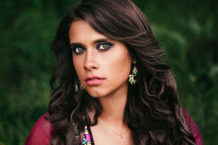 Portrait of a beautiful girl gypsy with green eyesの写真素材