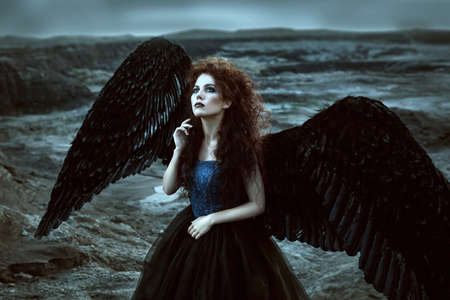 Pretty girl-demon with black wings behind her back